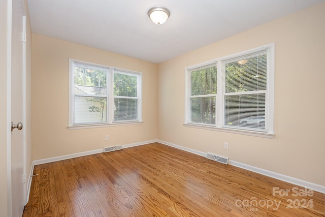 spare room featuring light hardwood / wood-style floors