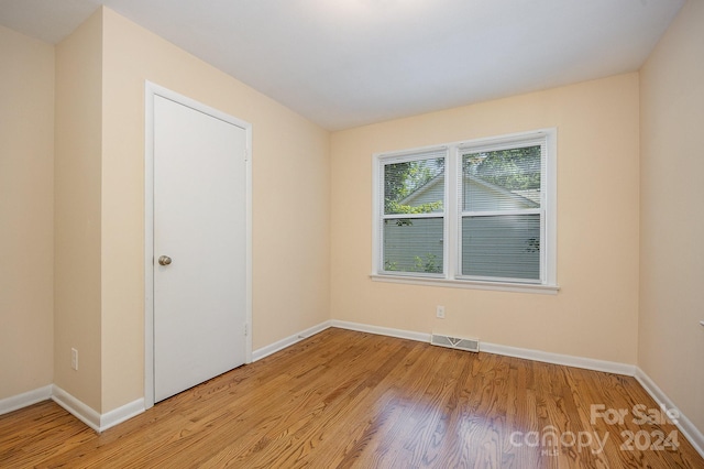 unfurnished room with light hardwood / wood-style flooring