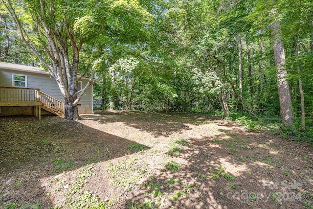 view of yard featuring a wooden deck