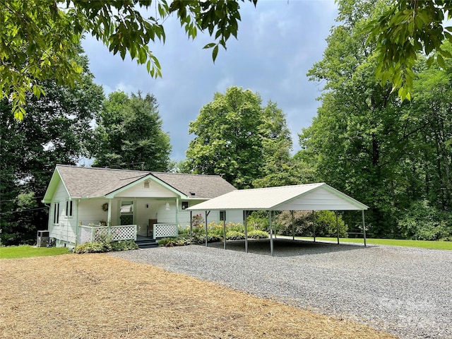 view of front of home with covered porch and a carport