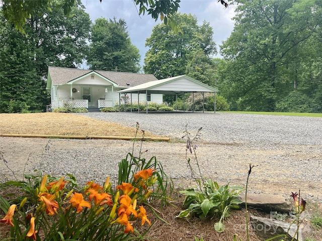 view of yard featuring a carport and a porch