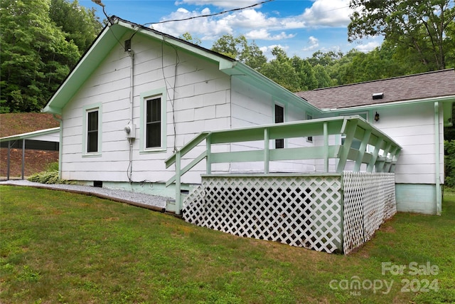 rear view of property featuring a yard