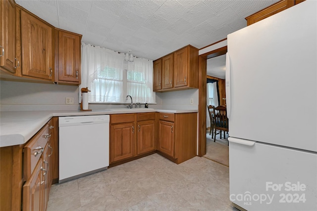 kitchen featuring sink and white appliances