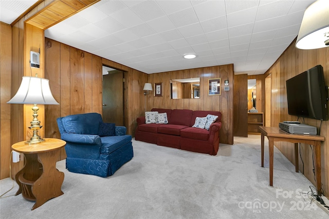 living room with light carpet and wood walls