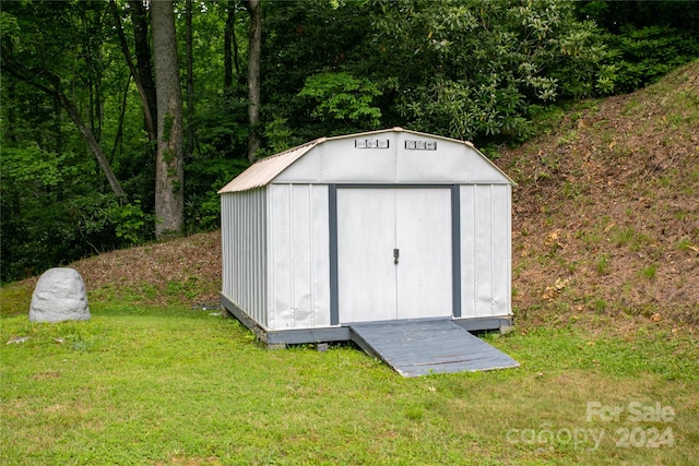 view of outbuilding with a lawn