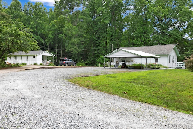 view of front of house featuring a front lawn and a carport