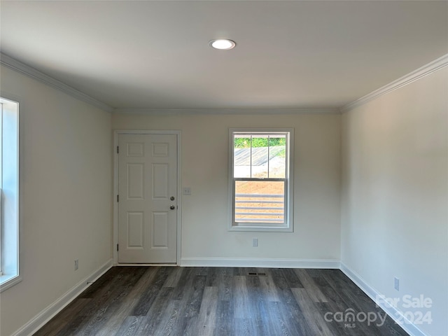 unfurnished room with dark wood-type flooring, crown molding, and baseboards