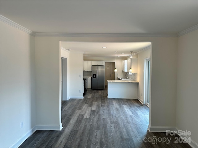 kitchen featuring a sink, white cabinetry, baseboards, stainless steel refrigerator with ice dispenser, and dark wood-style floors