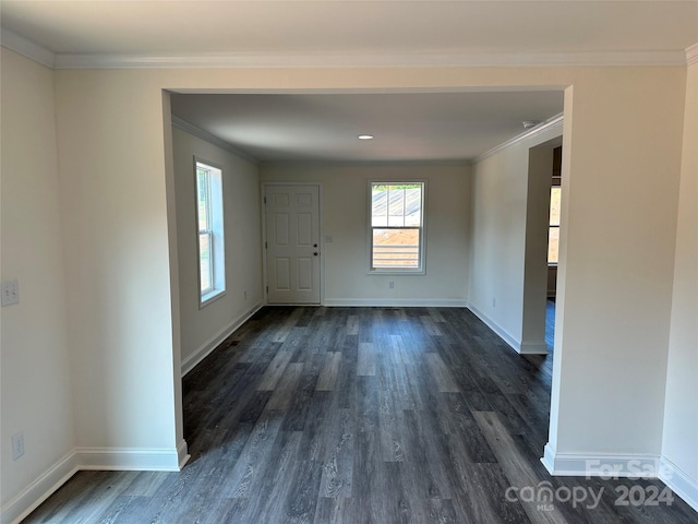 foyer entrance featuring ornamental molding, dark wood-style flooring, and baseboards