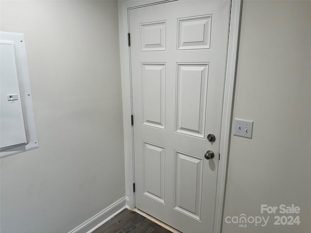 interior details featuring wood finished floors, electric panel, and baseboards