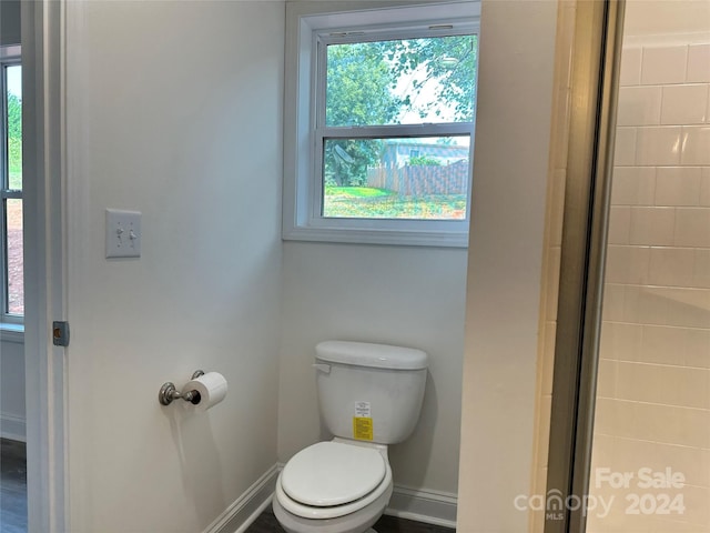 bathroom with baseboards and toilet