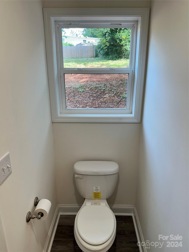 bathroom featuring toilet, baseboards, and wood finished floors