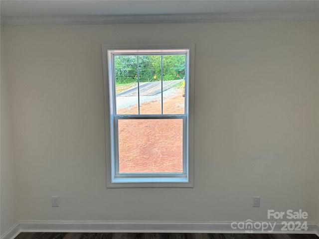 unfurnished room with crown molding and baseboards