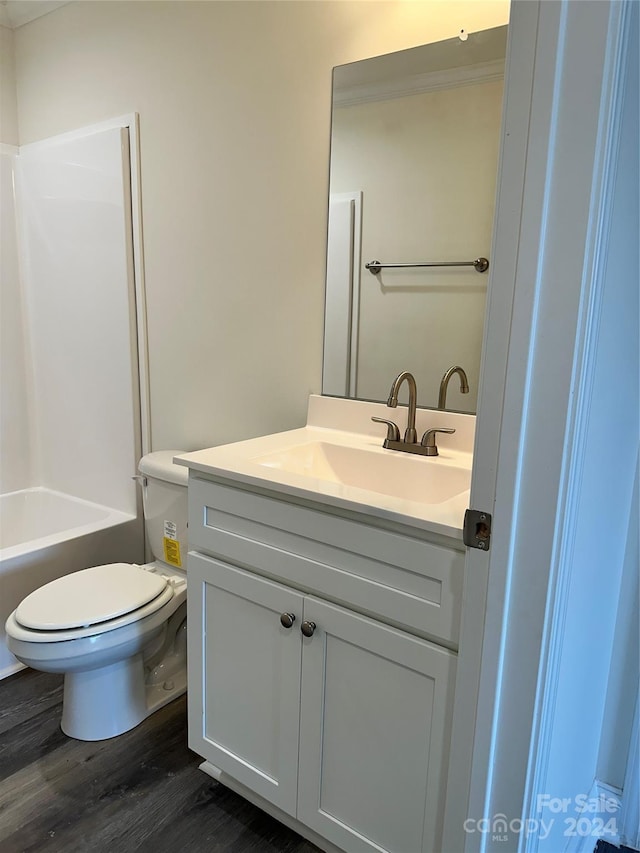 bathroom with vanity, toilet, and wood finished floors