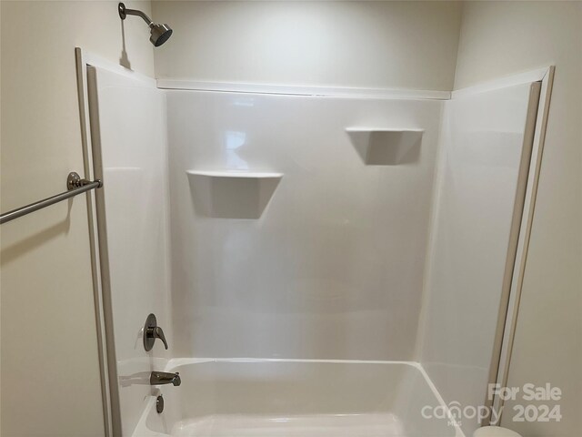 bathroom with toilet and tub / shower combination