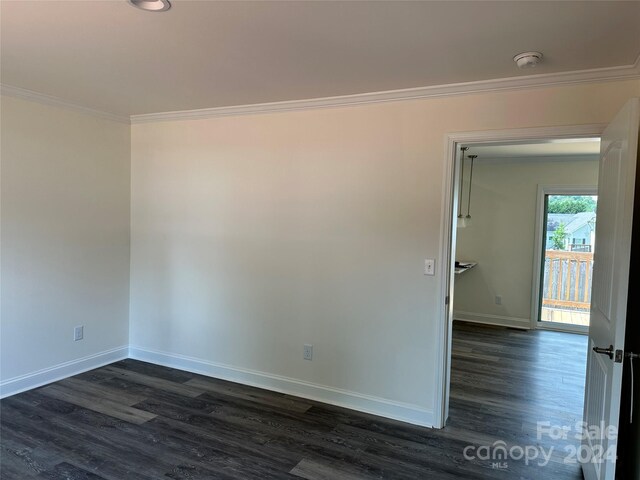 unfurnished room with dark hardwood / wood-style flooring and crown molding