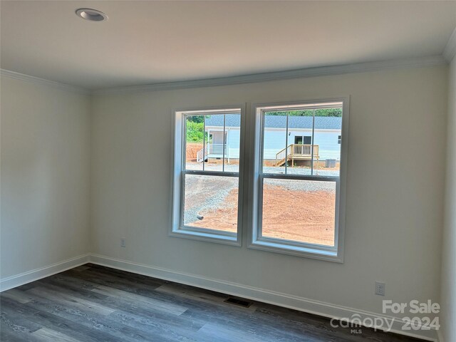 spare room with dark hardwood / wood-style flooring, a water view, and ornamental molding