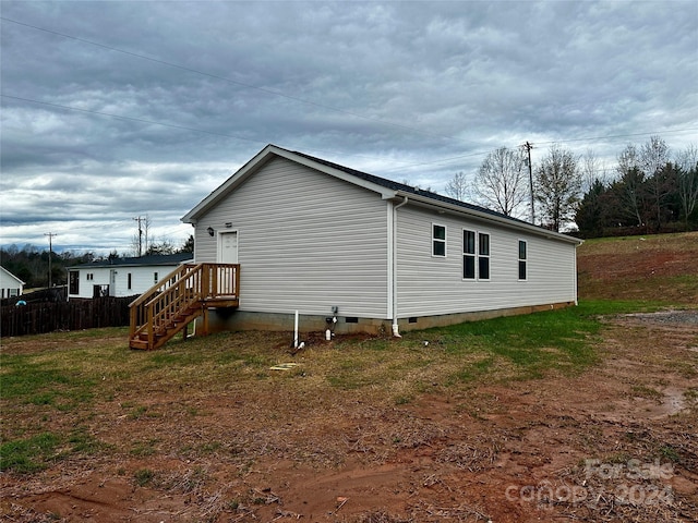 view of property exterior featuring a lawn