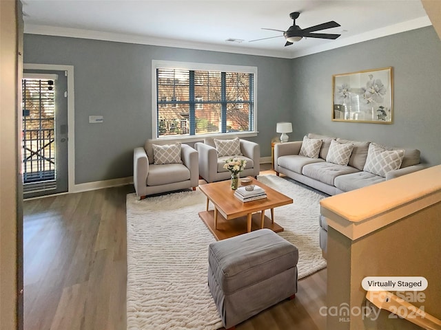 living room featuring dark hardwood / wood-style floors, ceiling fan, and crown molding