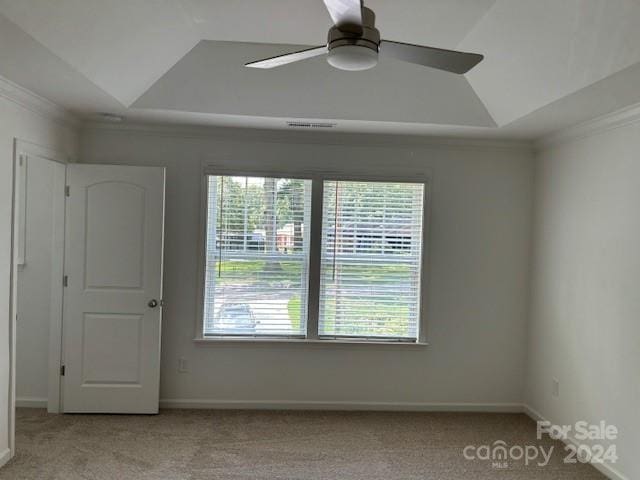 unfurnished room featuring ceiling fan, light colored carpet, lofted ceiling, and crown molding