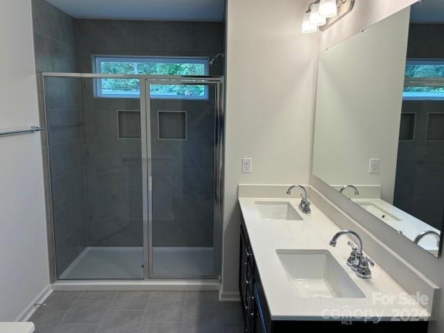 bathroom featuring tile patterned floors, vanity, and walk in shower