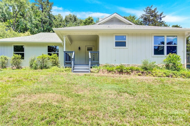 view of front of house with covered porch and a front yard