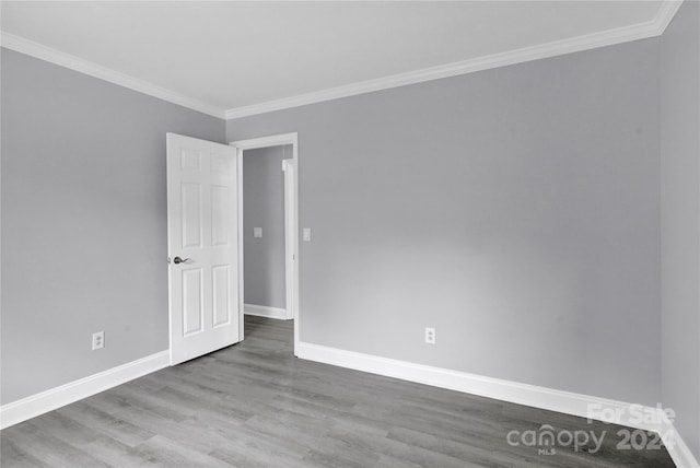 unfurnished room featuring hardwood / wood-style flooring and ornamental molding