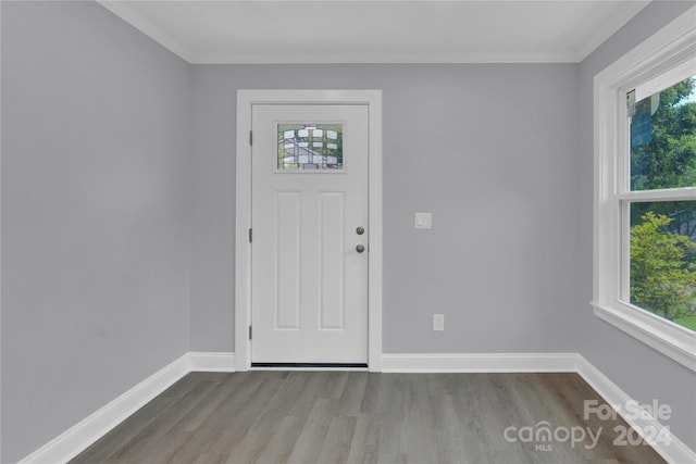 foyer with wood-type flooring and ornamental molding