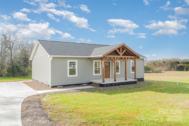 view of front of house with a front yard and a porch