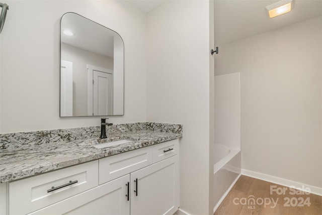 bathroom with hardwood / wood-style floors and vanity