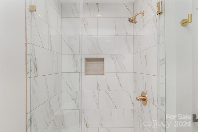 bathroom with a tile shower