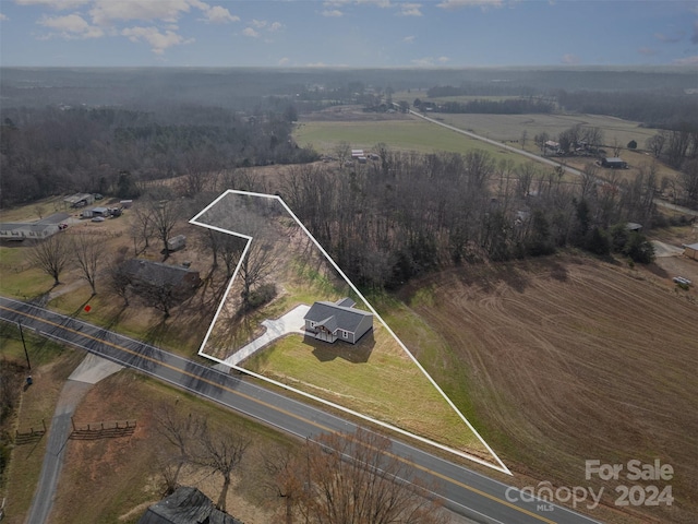 birds eye view of property with a rural view