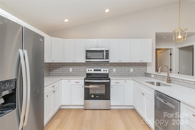 kitchen with white cabinets, decorative backsplash, sink, and appliances with stainless steel finishes