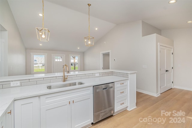 kitchen featuring white cabinetry, sink, stainless steel dishwasher, and decorative light fixtures