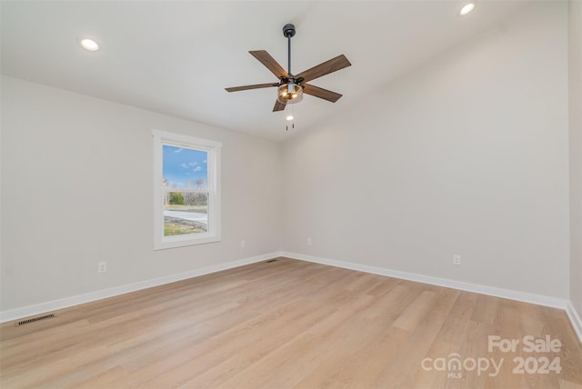 spare room featuring ceiling fan, light hardwood / wood-style floors, and lofted ceiling