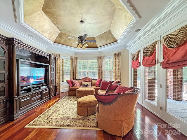 living room with ceiling fan, crown molding, dark hardwood / wood-style floors, and a raised ceiling