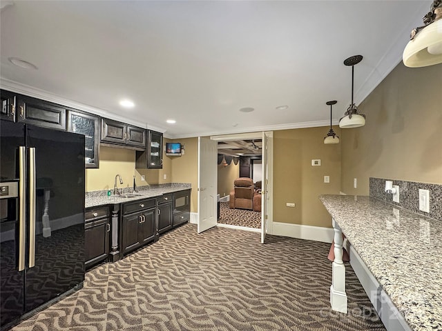 kitchen with dark colored carpet, sink, light stone counters, and black fridge with ice dispenser