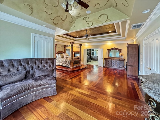 living room featuring ceiling fan, a raised ceiling, and crown molding