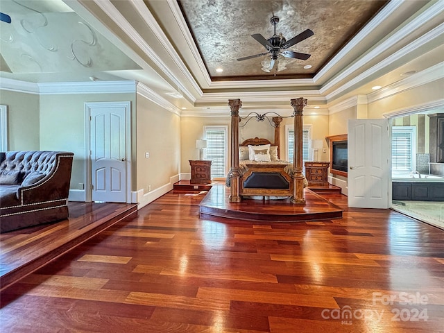 sitting room featuring ceiling fan, hardwood / wood-style flooring, a tray ceiling, and ornamental molding