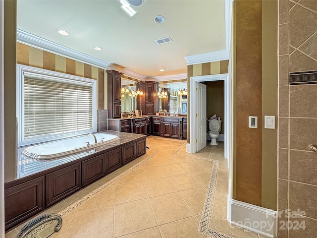 bathroom with a tub, vanity, crown molding, and tile patterned flooring