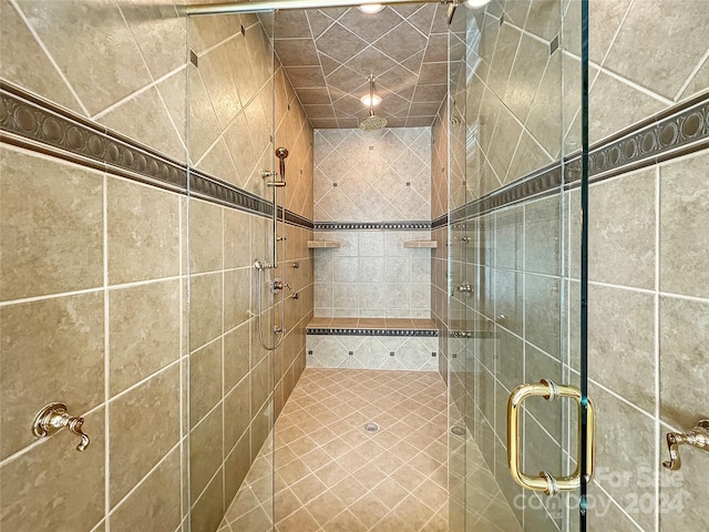 bathroom featuring a shower with shower door