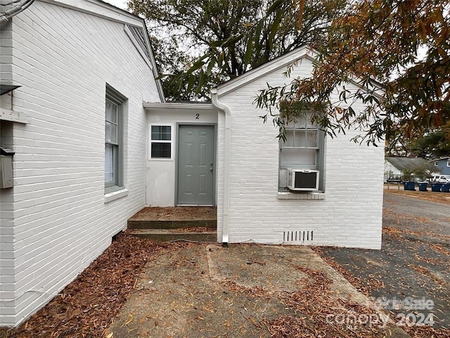 doorway to property featuring cooling unit