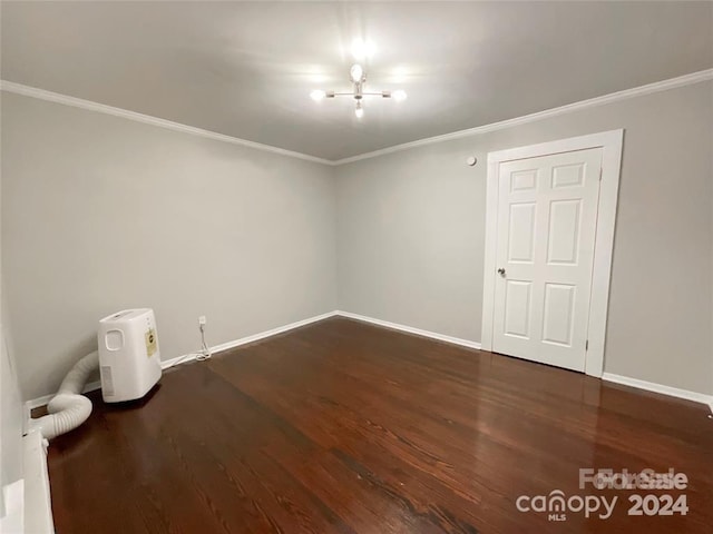 empty room featuring crown molding and dark hardwood / wood-style floors