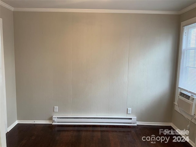 spare room with hardwood / wood-style floors, a baseboard heating unit, and ornamental molding