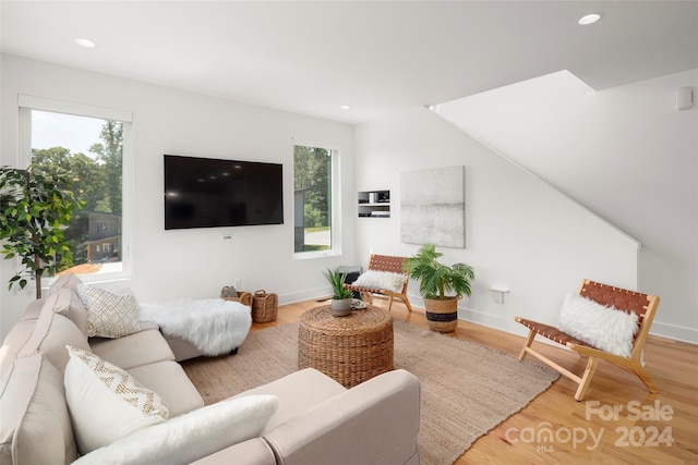 living room featuring recessed lighting, light wood-type flooring, and baseboards