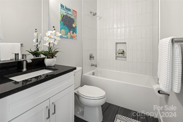 bathroom with shower / washtub combination, toilet, and vanity