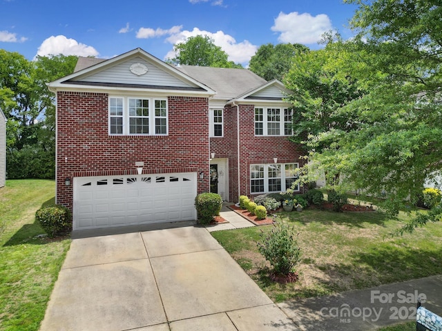 view of front of home with a garage and a front lawn