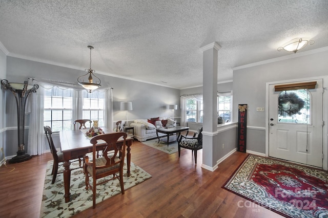 dining area with a textured ceiling, dark hardwood / wood-style floors, and ornamental molding