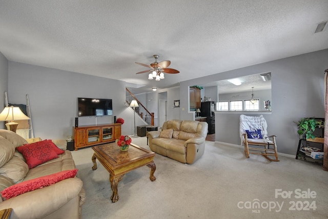 carpeted living room with a textured ceiling and ceiling fan