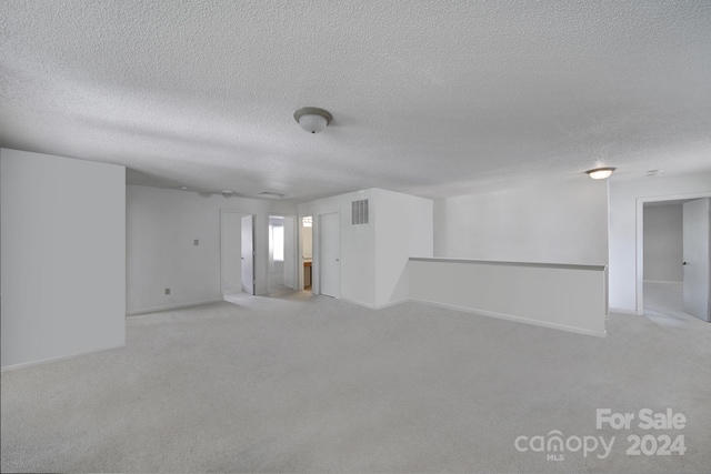 unfurnished room with a textured ceiling